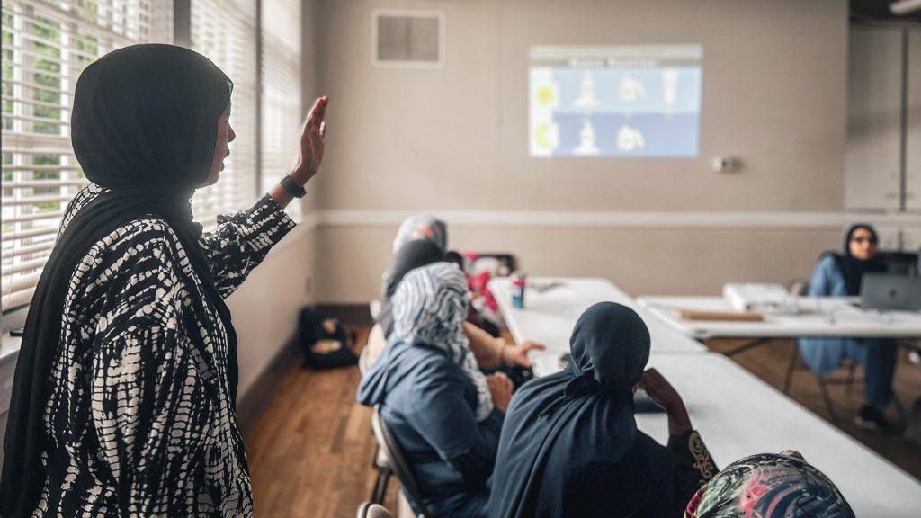 Twenty-five refugee and immigrant women learn about skincare at a Refugee Women’s Network Wellness Group led by an Emory healthcare professional and translated by Community Healthcare Workers